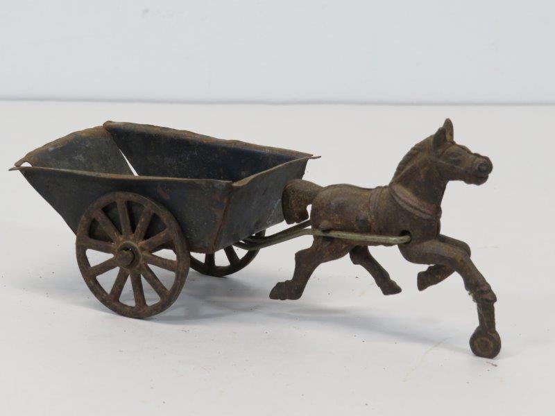 Antique Cast Iron Horse and Cart Toy: Believed to be incomplete. Blue tin cart bed has some separation at the corners. Paint is faded and there is some rusting, as noted in photos. Appropriate condition for age and play. 6 3/4" L 