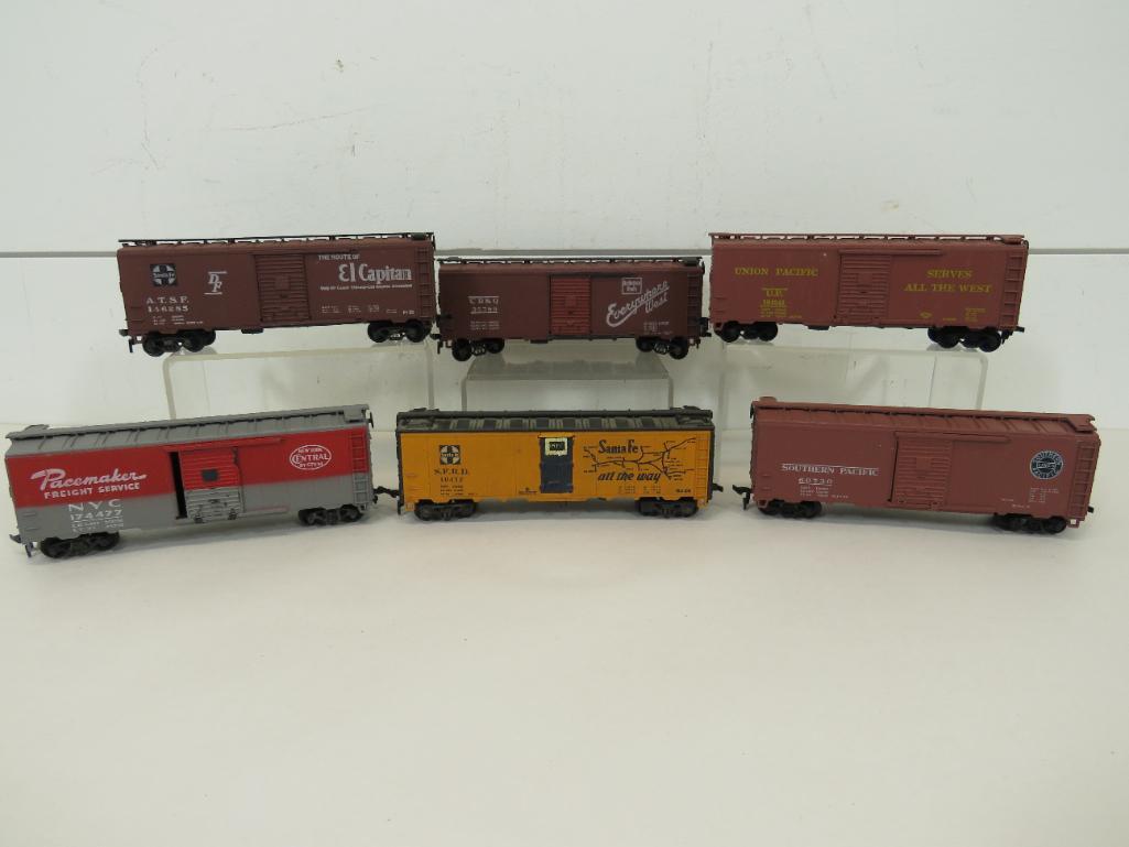 Athearn HO Scale Freight Cars w/Spring Trucks (6): This item is shippable. We offer combined shipping in-house. Dimensions: 5 3/4" Only 4 cars have spring trucks. Some surface rust on the bottoms and axles. Photos will serve to represent any oth
