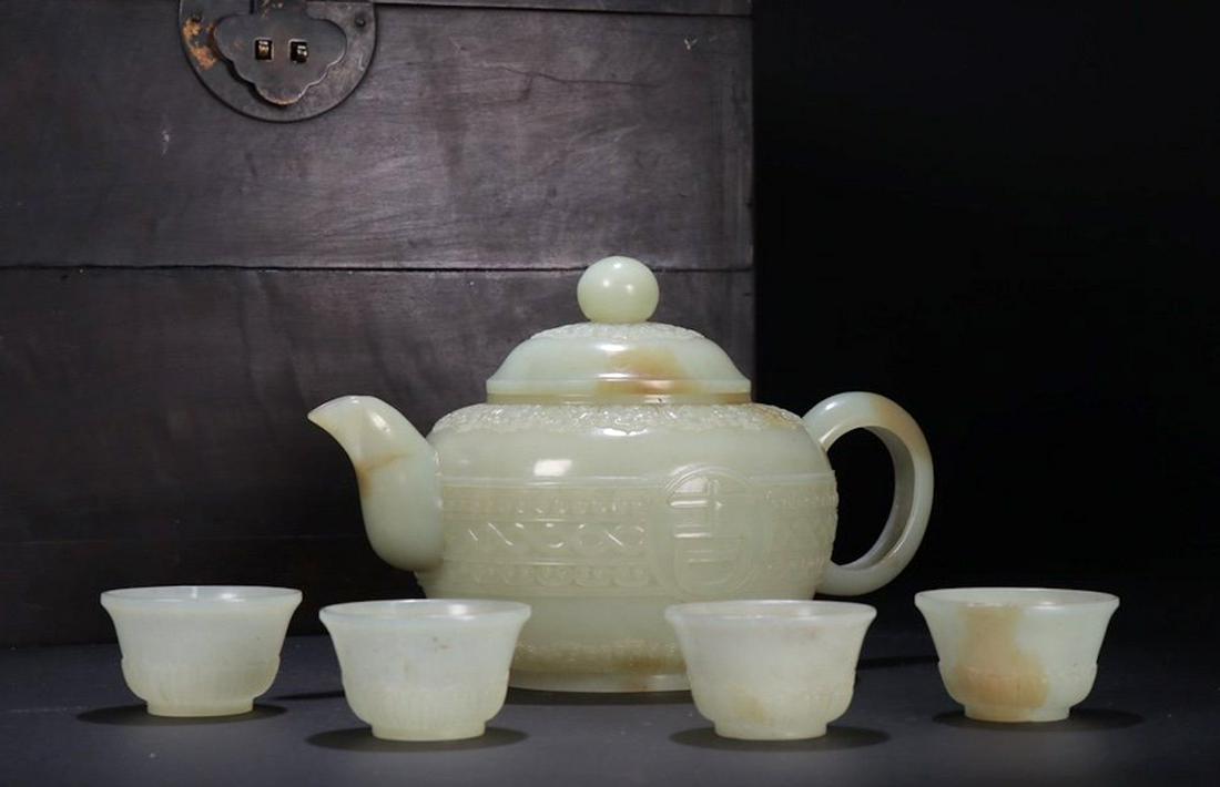 An Antique Set of Carved White Jade Teawares: An Antique Set of Carved White Jade Teawares Teapot:18.7x12.1x12cm;Cup:5x3cm;461.7g