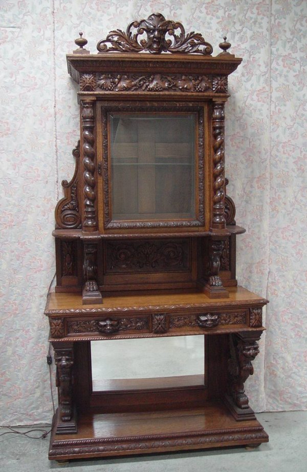 HEAVILY CARVED QUARTER SAWN OAK CABINET WITH GARGO