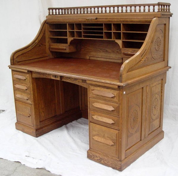 CARVED OAK S ROLL TOP DESK WITH CARVED RAISED PANE