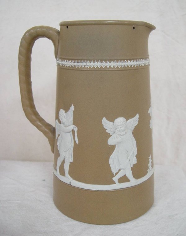 EARLY BROWN POTTERY TANKARD WITH APPLIED FIGURES 8
