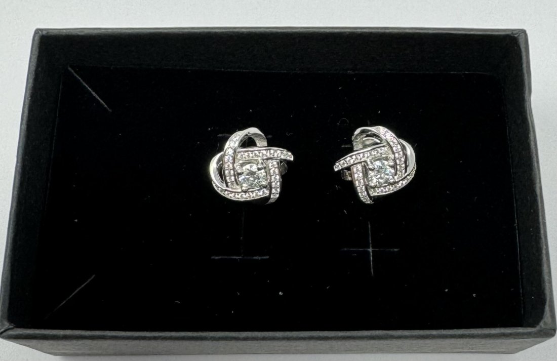Earrings Sparkling Moissanites: 18k White Gold Played on sterling silver Moissanite VVS1, Color Grade D , Weight: 0.3 carats each total of 0.6 carats pair . It comes with GRA Certificate. stone passes for Diamond Using a Diamond Tes
