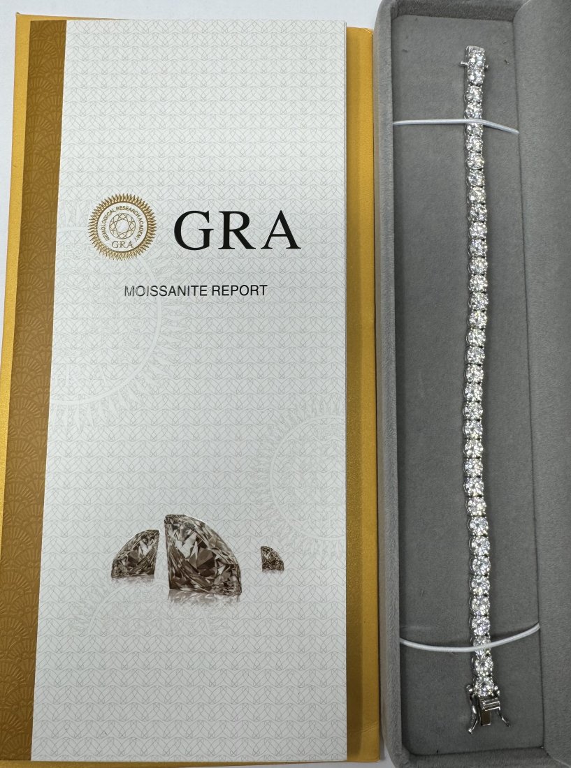 7 Inches Moissanite Bracelet 5MM: 18k White gold plated on sterling silver Moissanite Tennis Bracelet . Stones passes for diamond using diamond tester. It comes with certificate. Length: 7 inches 5 MM