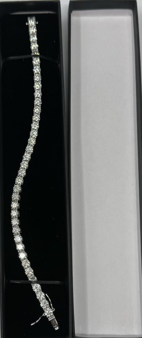 8 Inches Moissanite Bracelet 5MM: 18k White gold plated on sterling silver Moissanite Tennis Bracelet . Stones passes for diamond using diamond tester. It comes with certificate. Length: 8 inches 5 MM