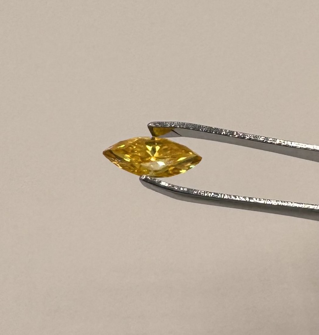 Golden Yellow Marquise Moissanite: Marquise Moissanite VVS1 Stone. Size: 2 Carats . Color: Golden Yellow. Stone comes with certificate of authenticity GRA. Stone passes for diamond using a diamond tester