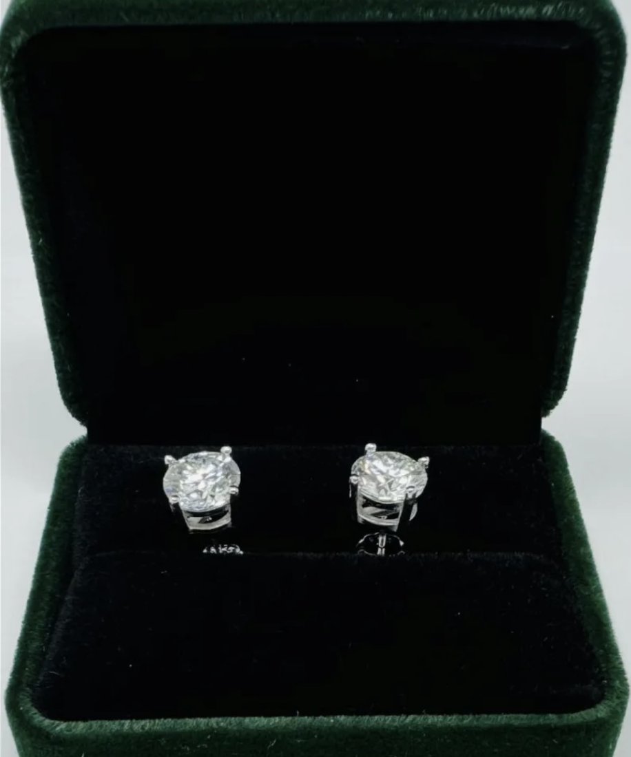 2 Carats Moissanite Earrings: 18k White Gold plated on sterling silver Pair of Moissanite VVS1 earrings , VVS1 Moissanite, Color Grade D , Weight: 2 carat each. It comes with GRA Certificate. stone passes for Diamond Using a Diamo