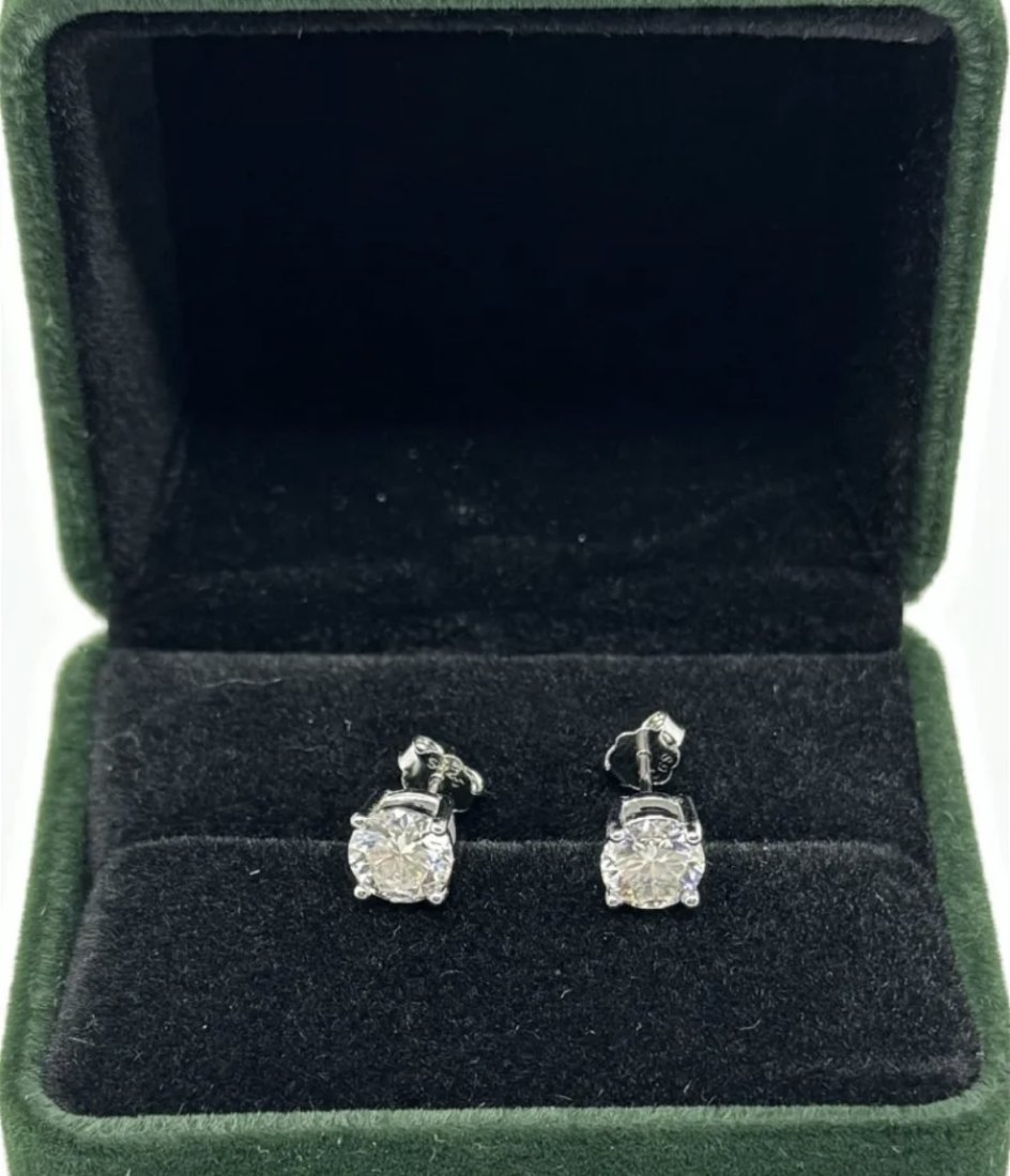 Moissanite Earrings: 18k White Gold plated on sterling silver Pair of Moissanite VVS1 earrings , VVS1 Moissanite, Color Grade D , Weight: 1 carat each. It comes with GRA Certificate. stone passes for Diamond Using a Diamo