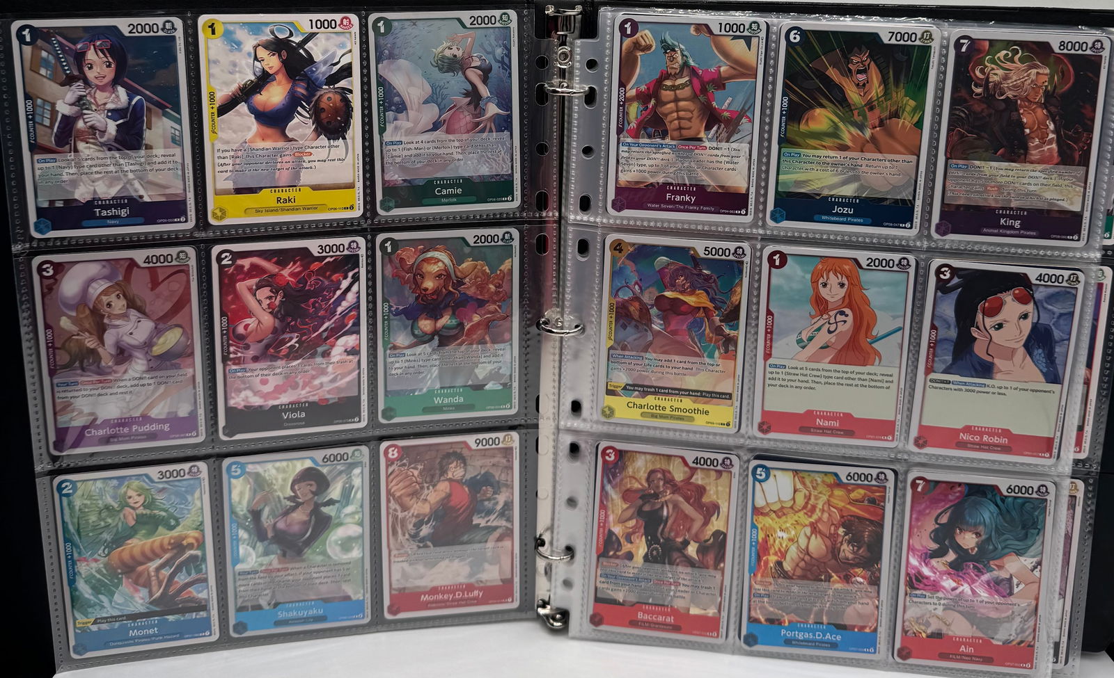 One Piece Binder: One Piece Trading Cards Binder. Monkey D Luffy, Tashigi, Raki, Monet, Nami, Ain, Portia’s and many more. Binder has foil one piece cards in the mix. Binder has over 200 cards