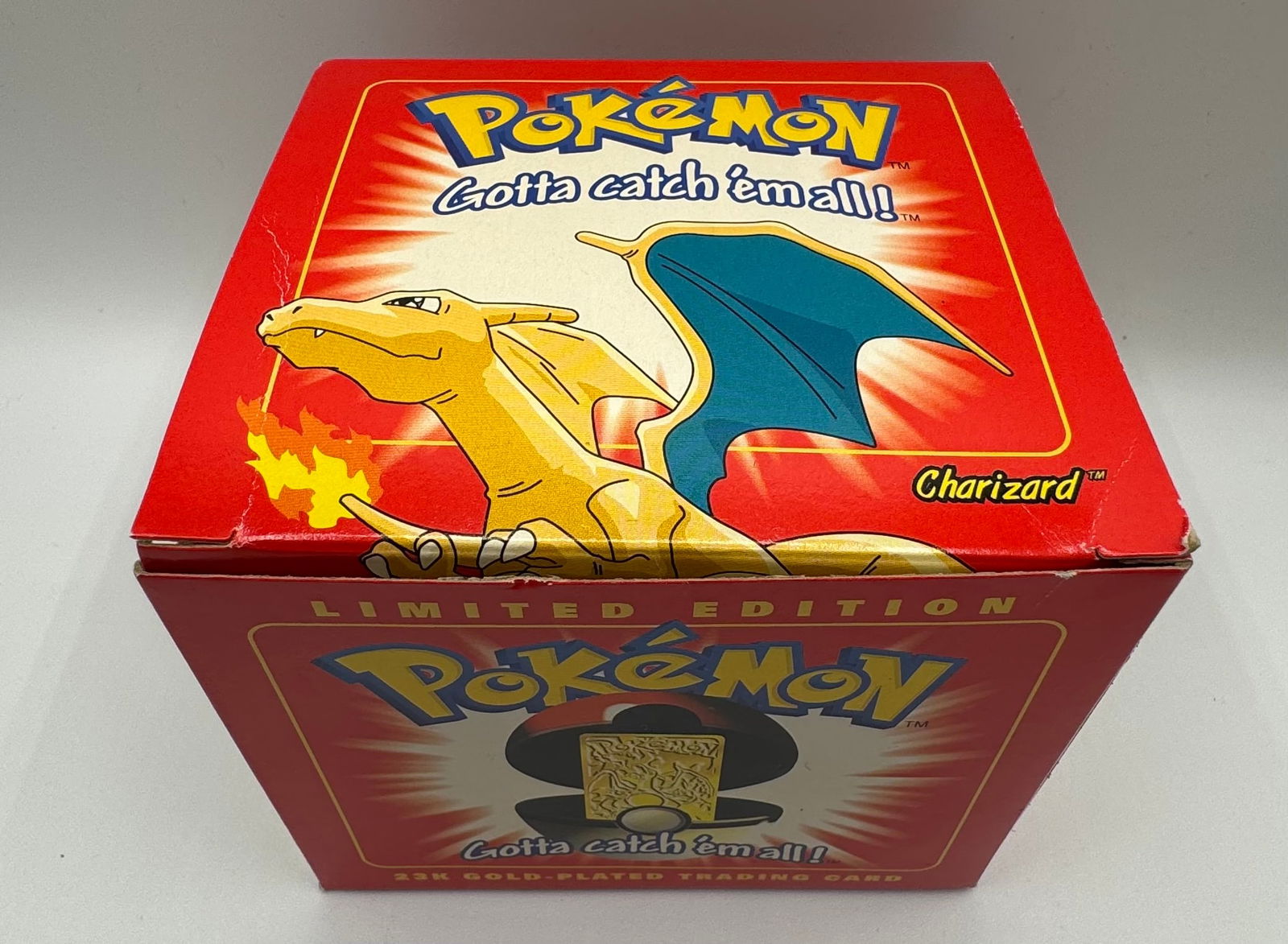 Sealed 1999 Charizard Pokemon Ball: Sealed 1999 Nintendo Charizard Pokemon Ball gold plated trading card . The Pokemon ball is sealed .