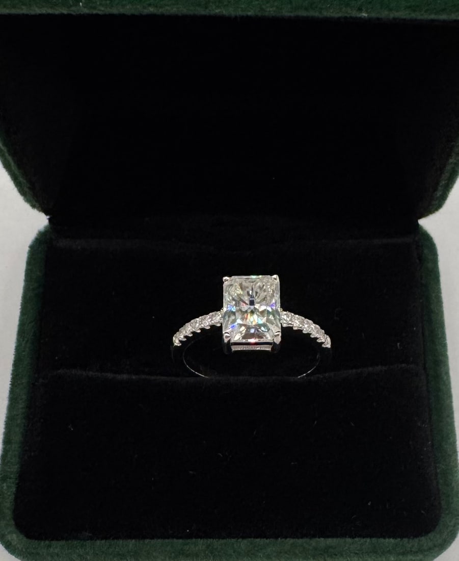 Radiant Moissanite Ring: 3 Carats Stone Moissanite Ring Mounted in Sterling with White Gold Overlay, with Certificate Of Authenticity & Jewelry Case. Size: 8 