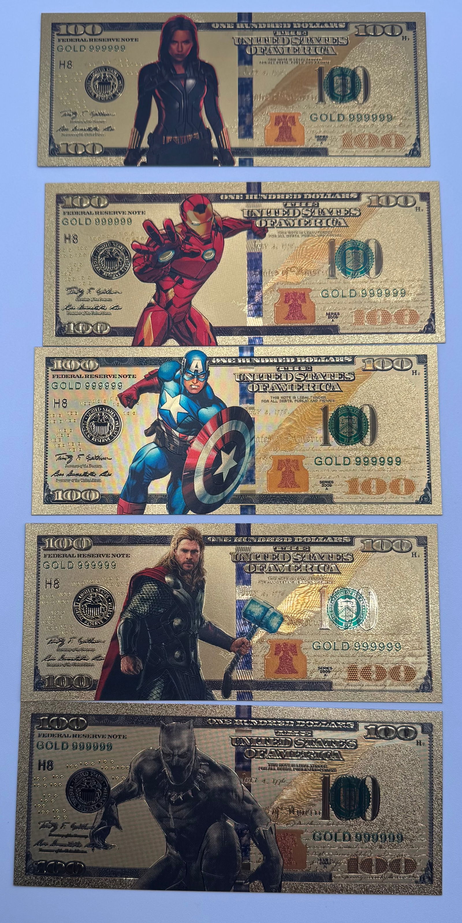 Lot of (5) Marvel Avengers Gold Foil Novelty Banknotes: Complete set of (5) Marvel-themed novelty $100 bills. Each note is gold-foil plated and features high-definition graphics of: Black Widow, Iron Man, Captain America, Thor, and Black Panther. These