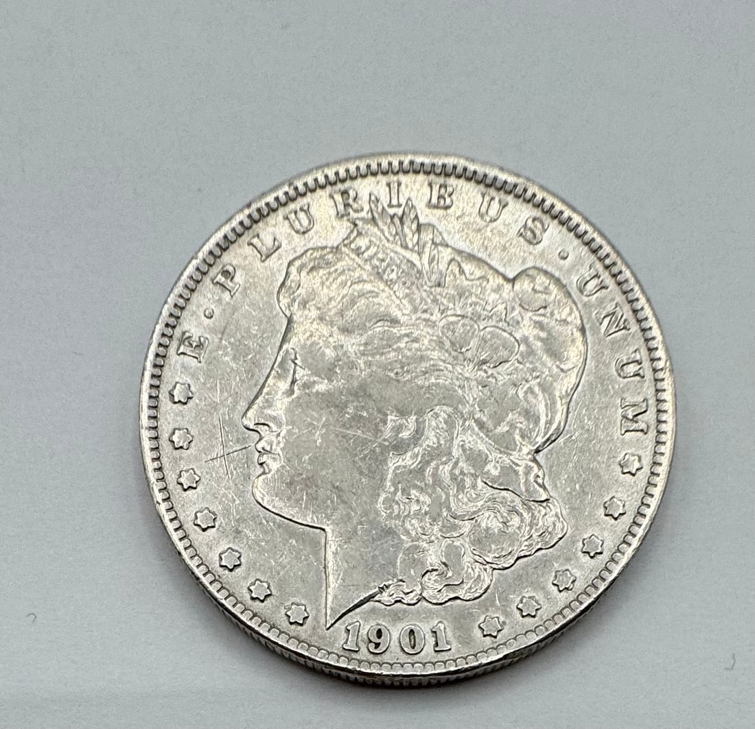1901-O Morgan Silver Dollar - New Orleans Mint: Up for auction is a classic 1901-O Morgan Silver Dollar, struck at the historic New Orleans Mint. This coin features the iconic Liberty head design by George T. Morgan on the obverse and the heraldic