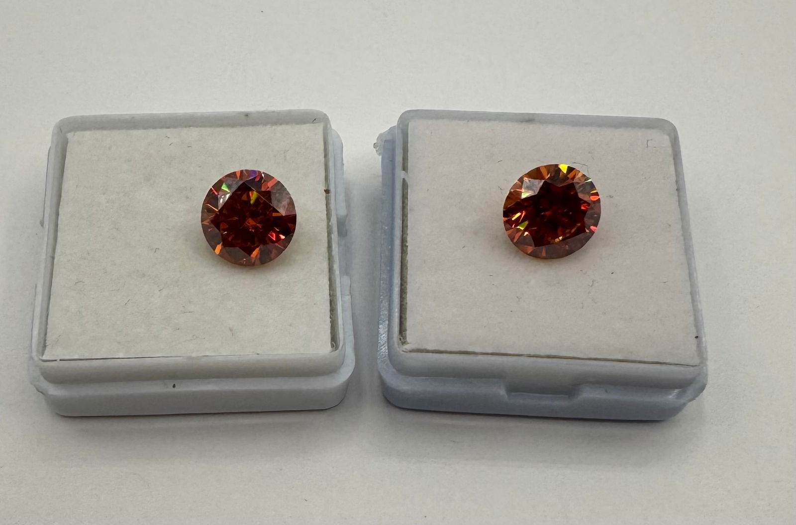 Matched Pair (2pcs) Round Brilliant Orange Moissanite - Diamond Tester Positive: Quantity: Two (2) matching loose gemstones. • Gemstone Type: Authentic Lab-Created Moissanite. • Color: Deep Orange Red /. • Cut: Excellent Round Brilliant. • Testing: