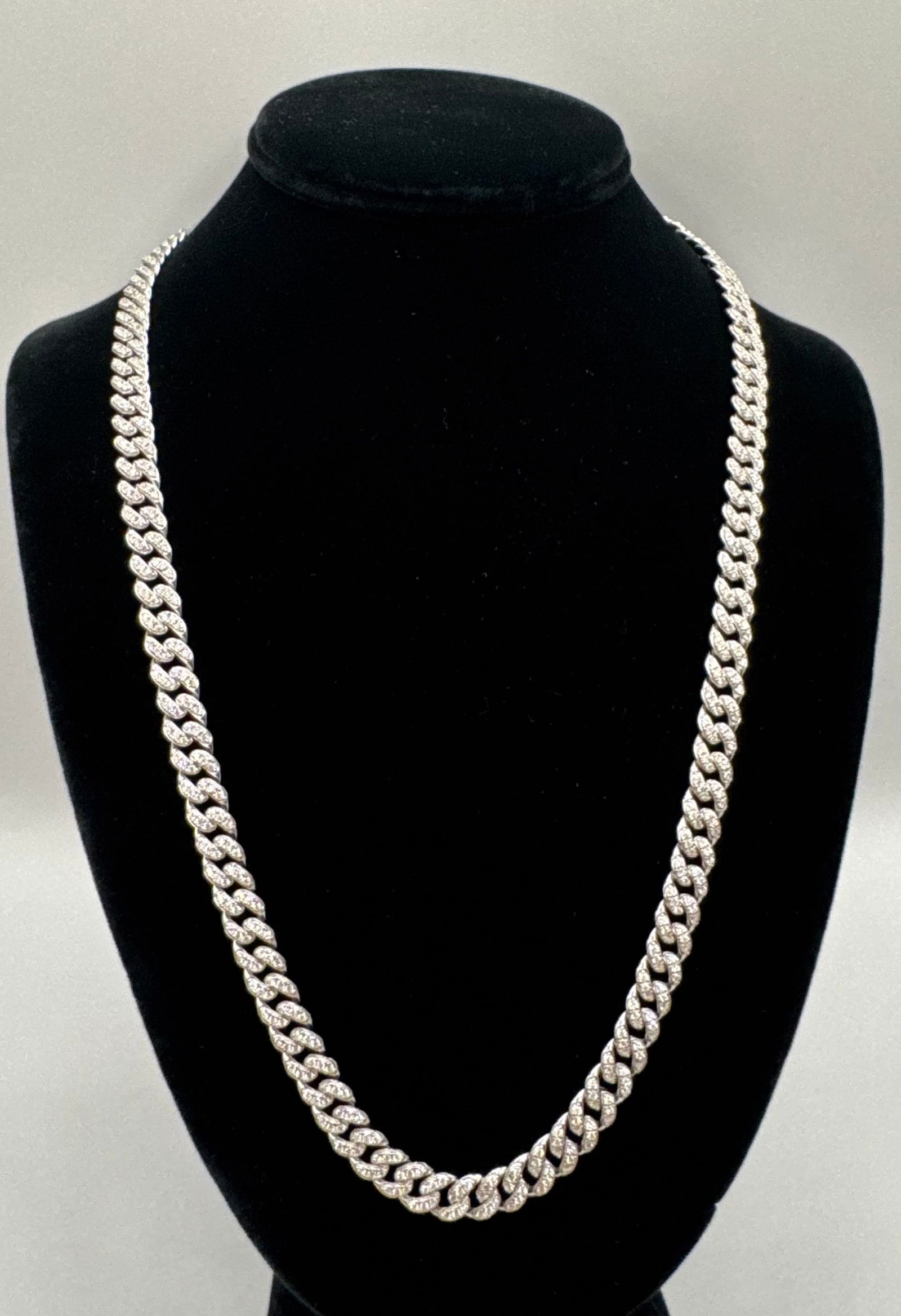 24" Moissanite Miami Cuban Link Chain - 18K White Gold Plated Sterling Silver: Chain Type: Classic Miami Cuban link with a fully "iced-out" pavé setting. • Stones: Lab-created Round Brilliant Cut Moissanites (D-E-F Colorless, VVS clarity). • Metal: Solid .925