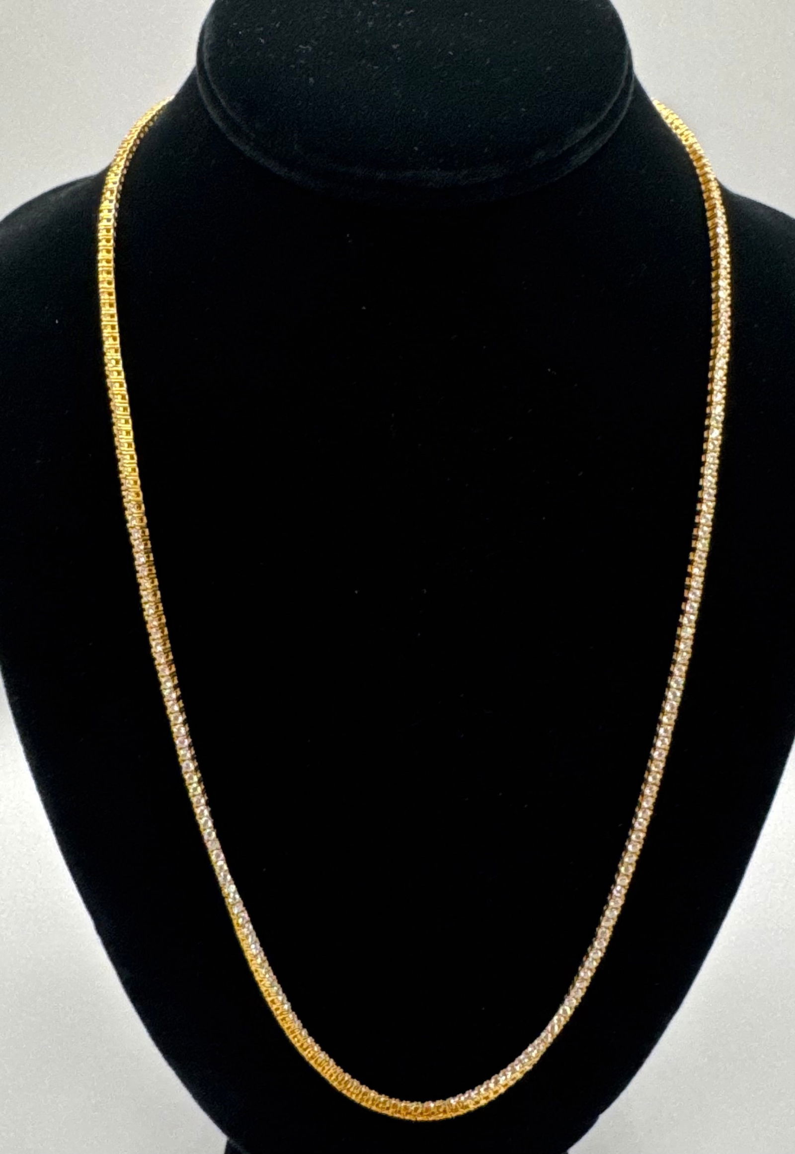 24" Moissanite Tennis Necklace (2mm) - VVS1 D Color - 18K Gold over 925 Silver: Up for auction is a sophisticated 24-inch tennis necklace, precision-set with a continuous row of 2mm moissanite stones. This length is ideal for those who prefer a longer, more relaxed drape.