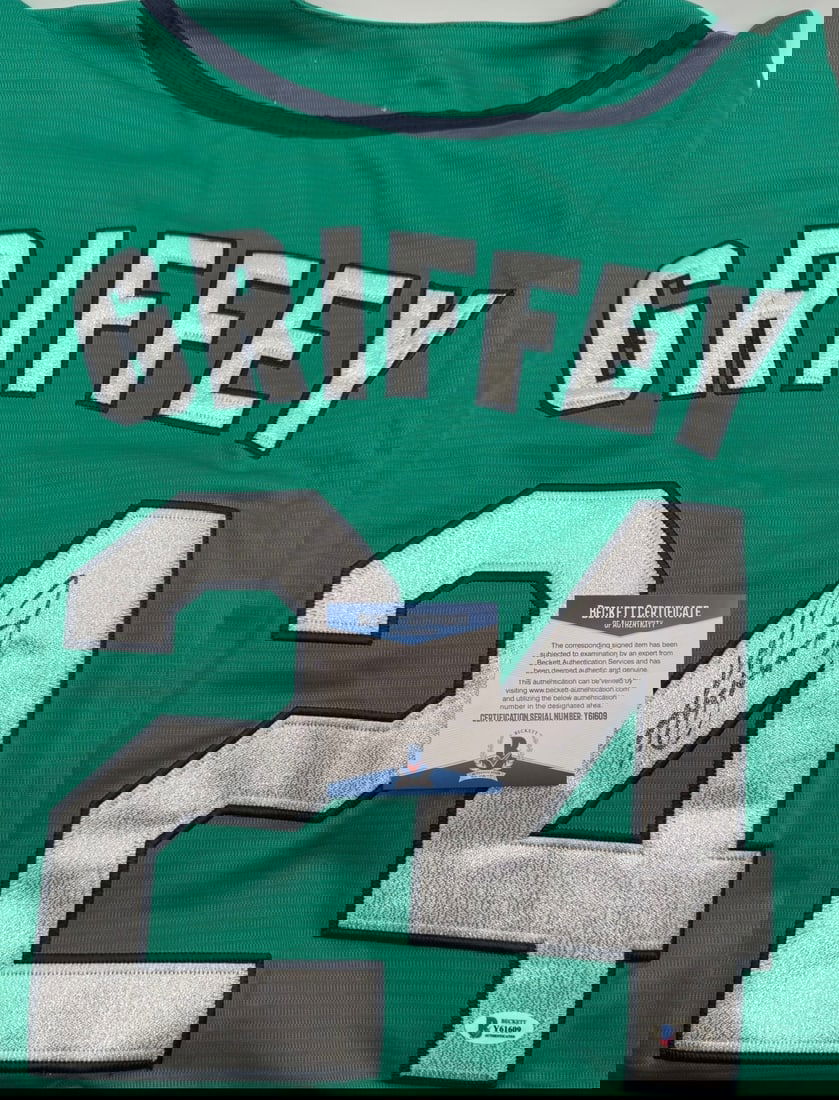 Ken Griffey Jr. Signed Seattle Mariners Custom Jersey – Beckett Authenticated: Up for auction is a stunning Ken Griffey Jr. autographed custom baseball jersey, featuring the iconic Seattle Mariners teal colorway. This jersey prominently displays "GRIFFEY" and his legendary numbe