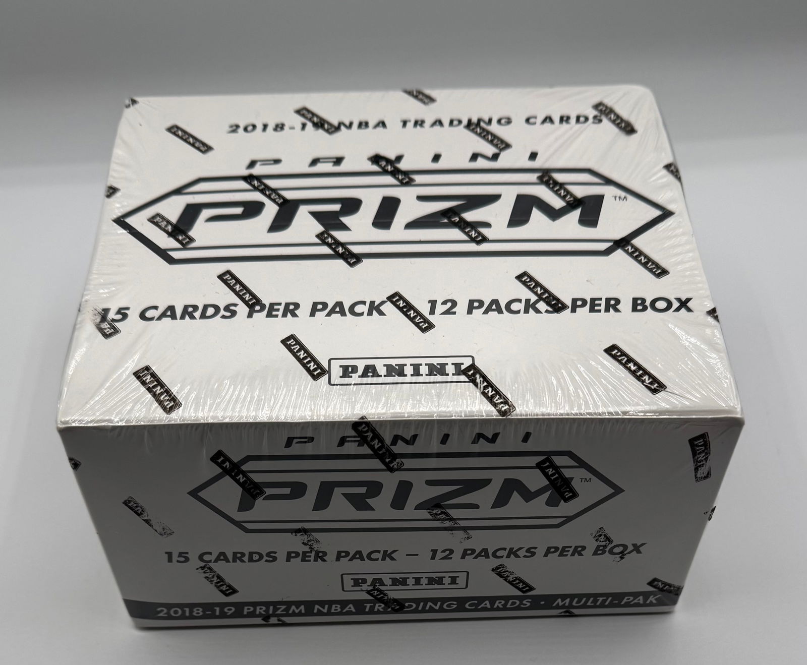2018-19 Panini Prizm NBA Basketball Multi-Pak Cello Box – Factory Sealed: Year/Brand: 2018-19 Panini Prizm NBA Trading Cards. • Box Configuration: 12 packs per box, with 15 cards per individual pack (Total of 180 cards). • Condition: Factory Sealed / New Old