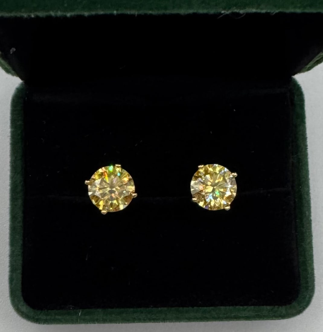 6 Carat Total Weight GRA Certified Moissanite Earrings in 18K Yellow Gold Plated Silver: Up for auction is a stunning pair of high-brilliance Round Brilliant Cut Moissanite stud earrings, totaling a massive 6.00 carats. These stones offer incredible fire and scintillation, rivaling the fi