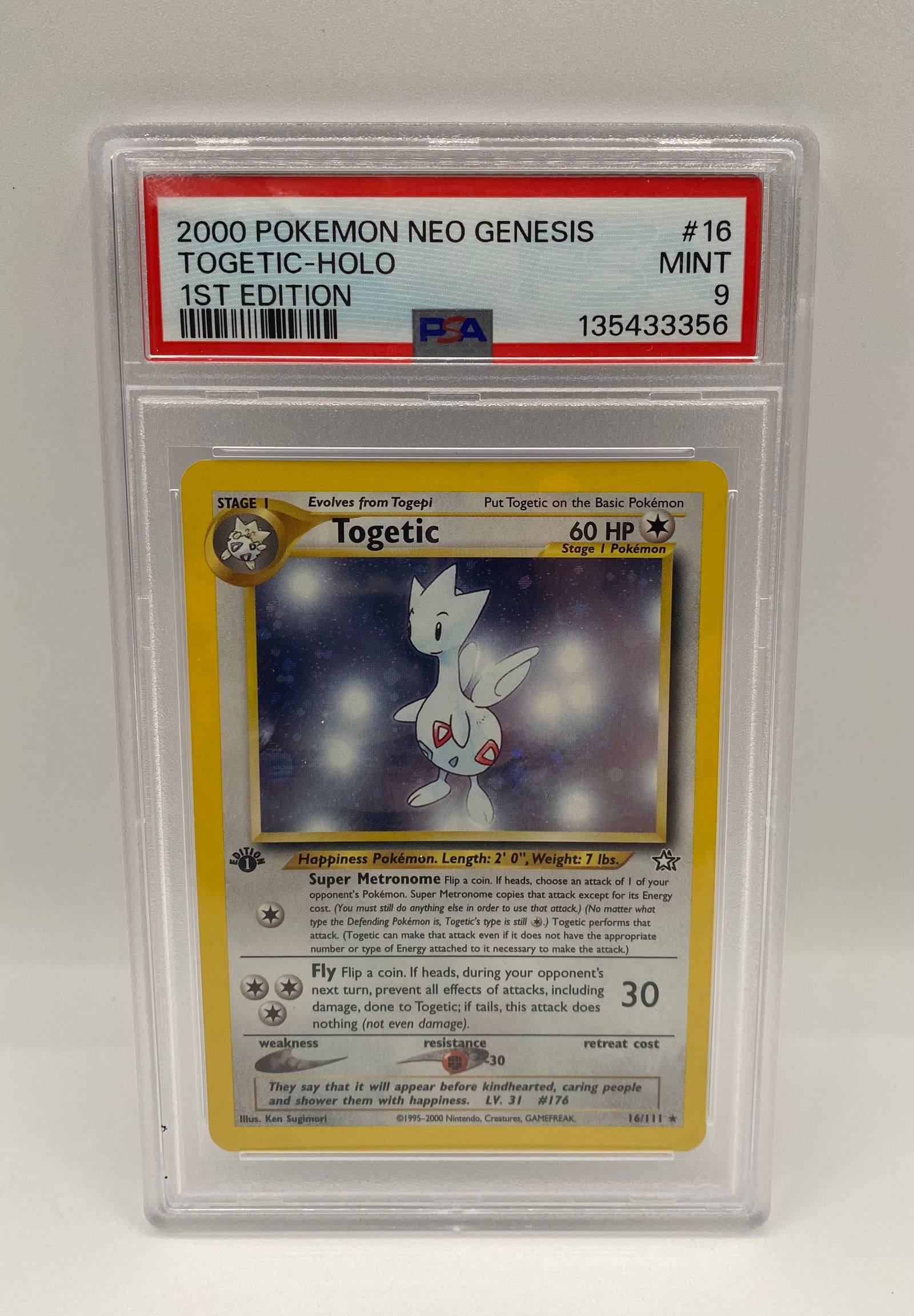 2000 Pokémon Neo Genesis 1st Edition Togetic Holo #16 – PSA 9 Mint: This lot features a highly sought-after 1st Edition Togetic Holo from the classic Neo Genesis set. Professionally graded by PSA as a 9 (Mint), this card remains in exceptional condition with vibrant