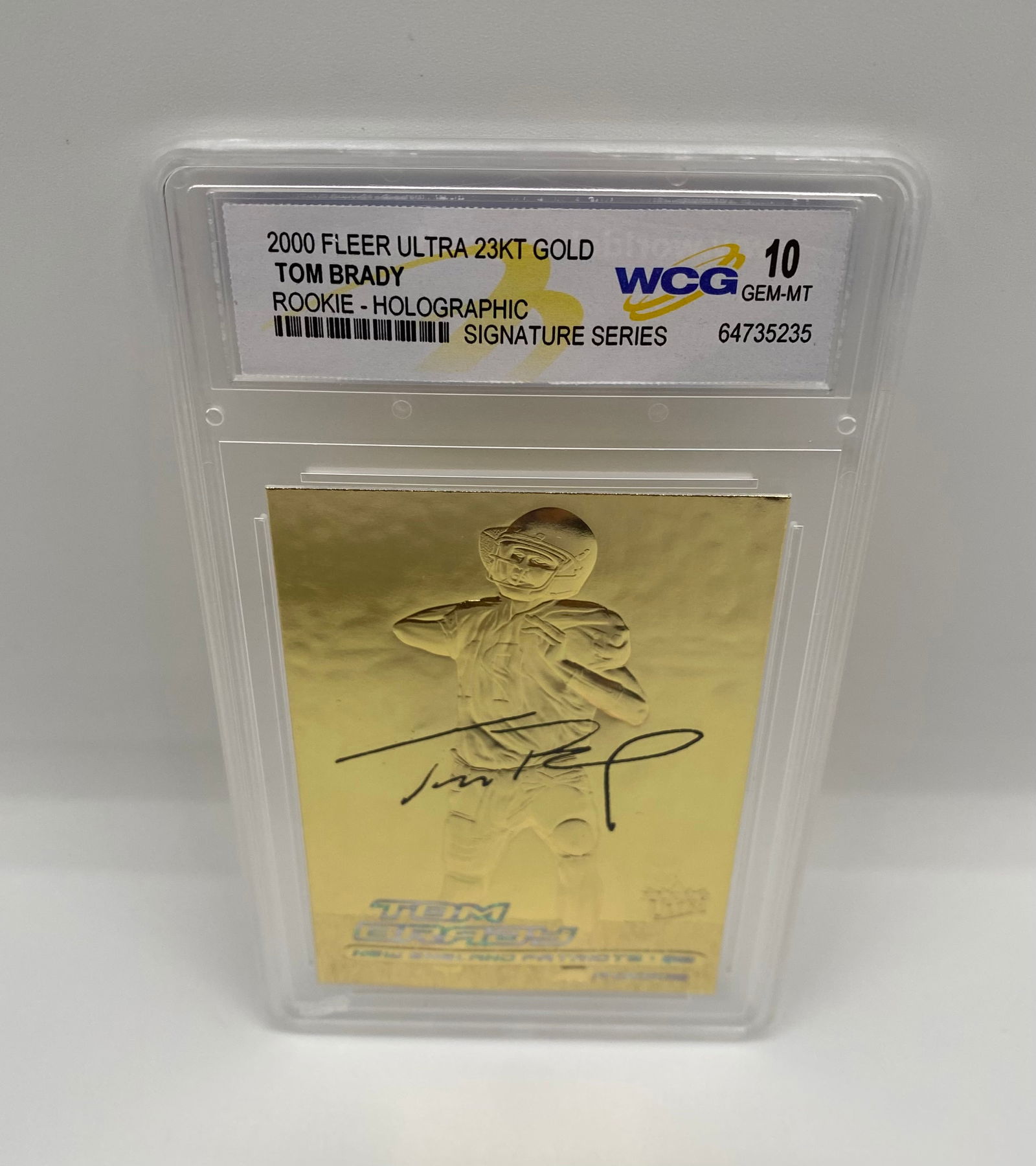 2000 Fleer Ultra 23KT Gold Tom Brady Rookie Holographic - WCG 10 GEM-MT: A 23-karat gold sculpted rookie card of the GOAT, Tom Brady. This "Signature Series" holographic edition is graded GEM-MT 10 by WCG. Features a facsimile signature and high-shine gold finish. 