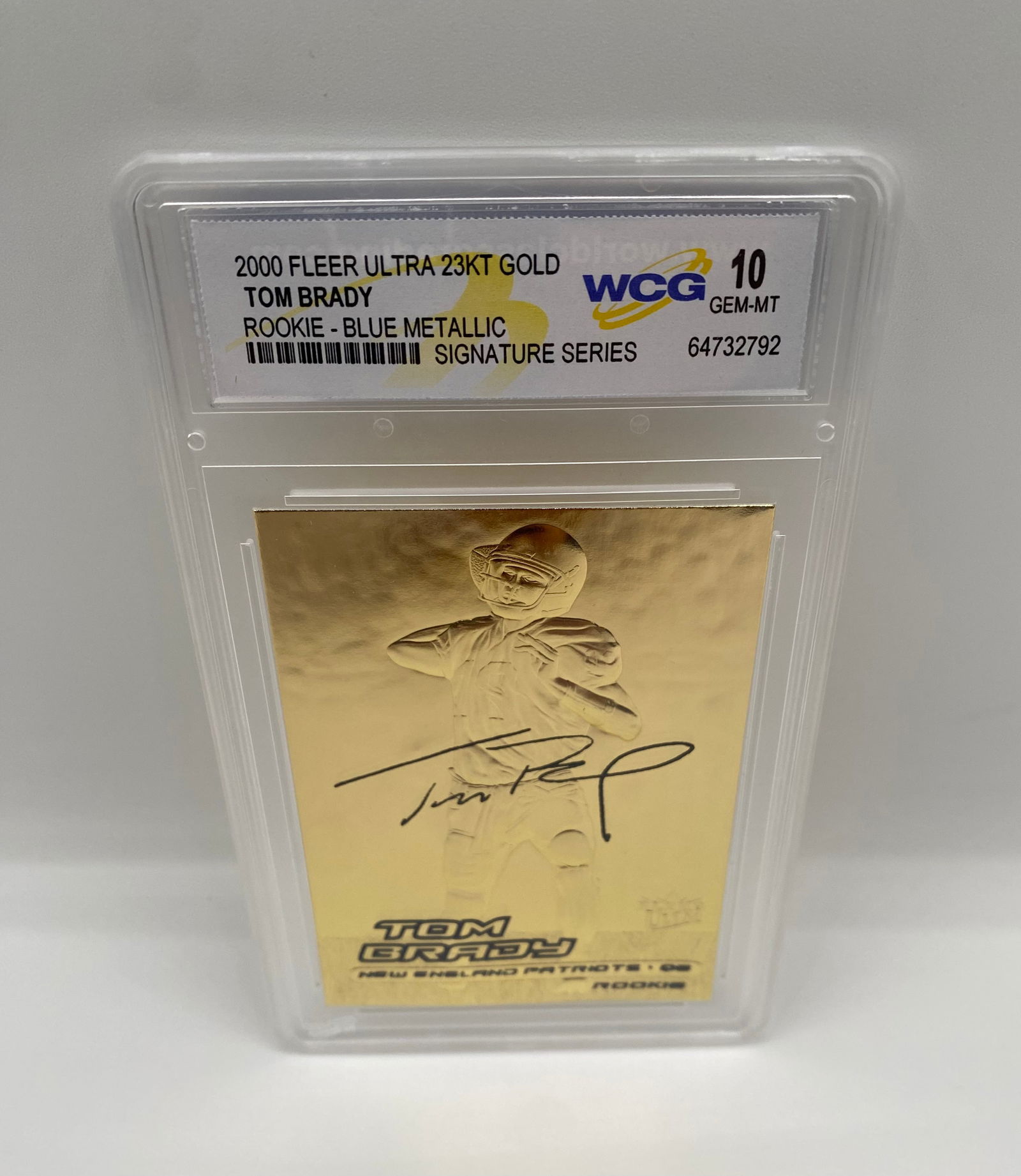 2000 Fleer Ultra 23KT Gold Tom Brady Rookie Blue Metallic - WCG 10 GEM-MT: A rare variant of the 23KT Gold Tom Brady rookie series, featuring the Blue Metallic label designation. Graded GEM-MT 10 by WCG. A flashy, high-grade commemorative of Brady’s rookie season. 