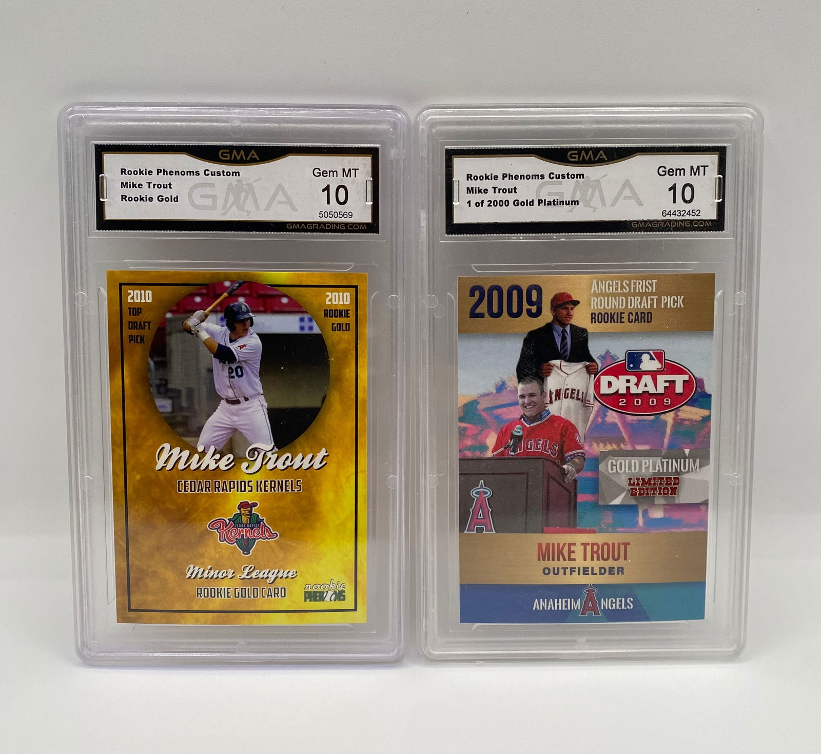 Mike Trout Graded Card Pair - 2009 Draft Pick & Minor League - All Gem MT 10: Two-card lot of 3x MVP Mike Trout. Graded Gem Mint 10 by GMA. • (1) 2009 Rookie Phenoms Custom Gold Platinum 1 of 2000 - Angels First Round Pick • (1) 2010 Rookie Phenoms Custom Rookie