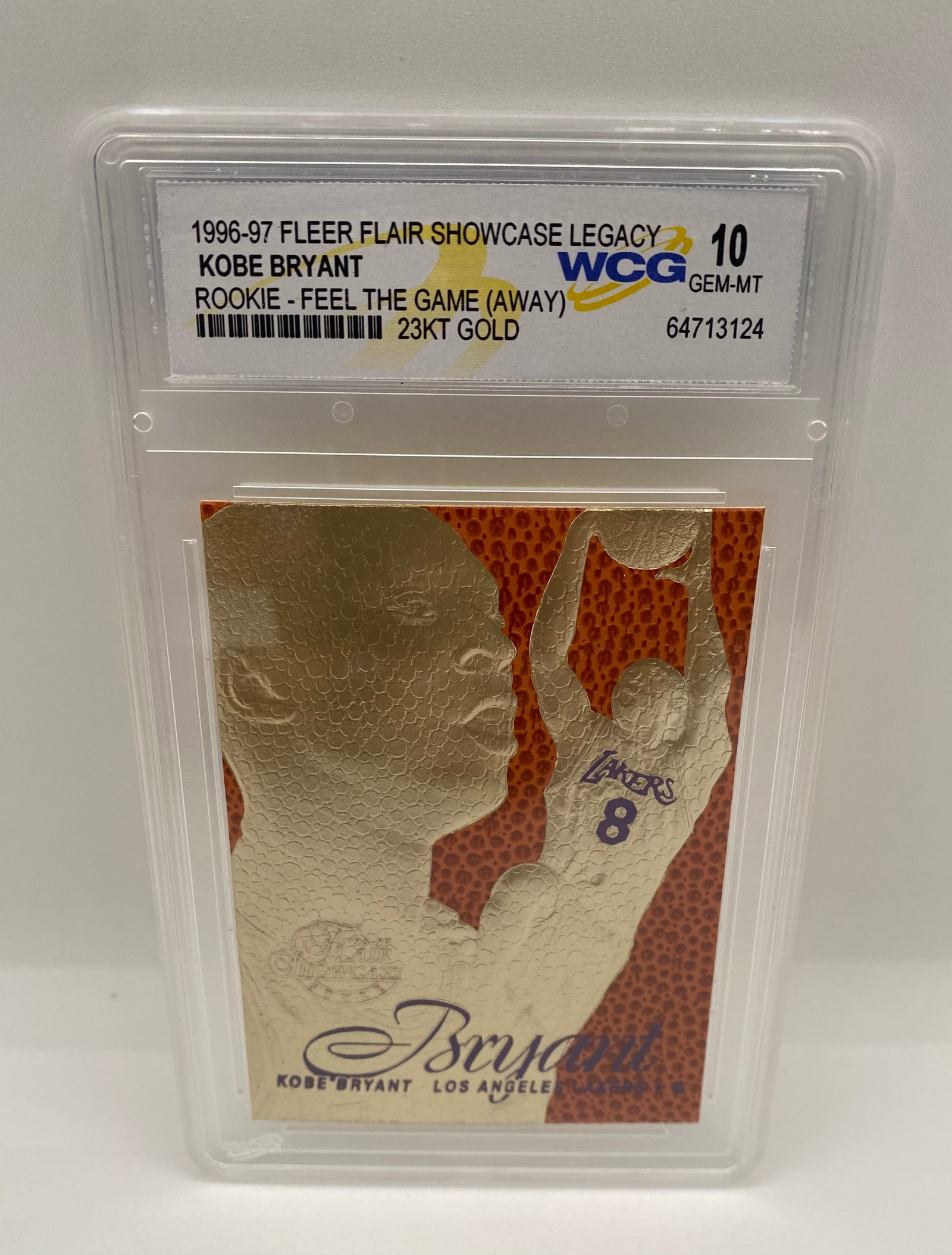 1996-97 Fleer Flair Showcase Legacy Kobe Bryant Rookie 23KT Gold - WCG 10 Gem-MT: A stunning gold-foil rookie commemorative card of the "Black Mamba." This card features the "Feel the Game" textured basketball surface. Graded a perfect Gem-Mint 10 by WCG. A must-have for any Kobe