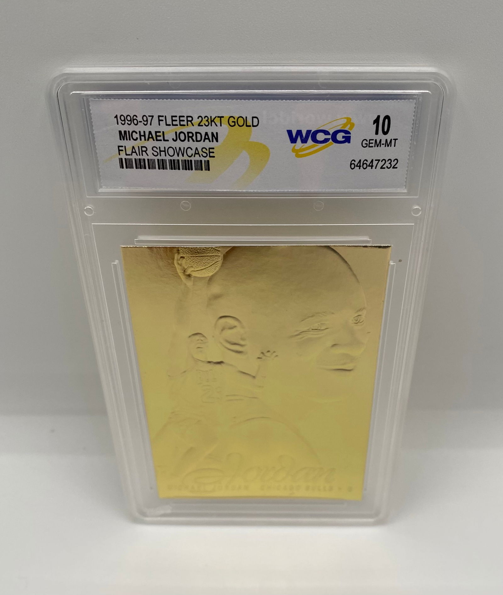 1996-97 Fleer Michael Jordan Flair Showcase 23KT Gold - WCG 10 Gem-MT: An elegant, minimalist gold-plated card from the Flair Showcase line. This card features a deep-etched portrait of Michael Jordan. Graded WCG 10 Gem-MT. 