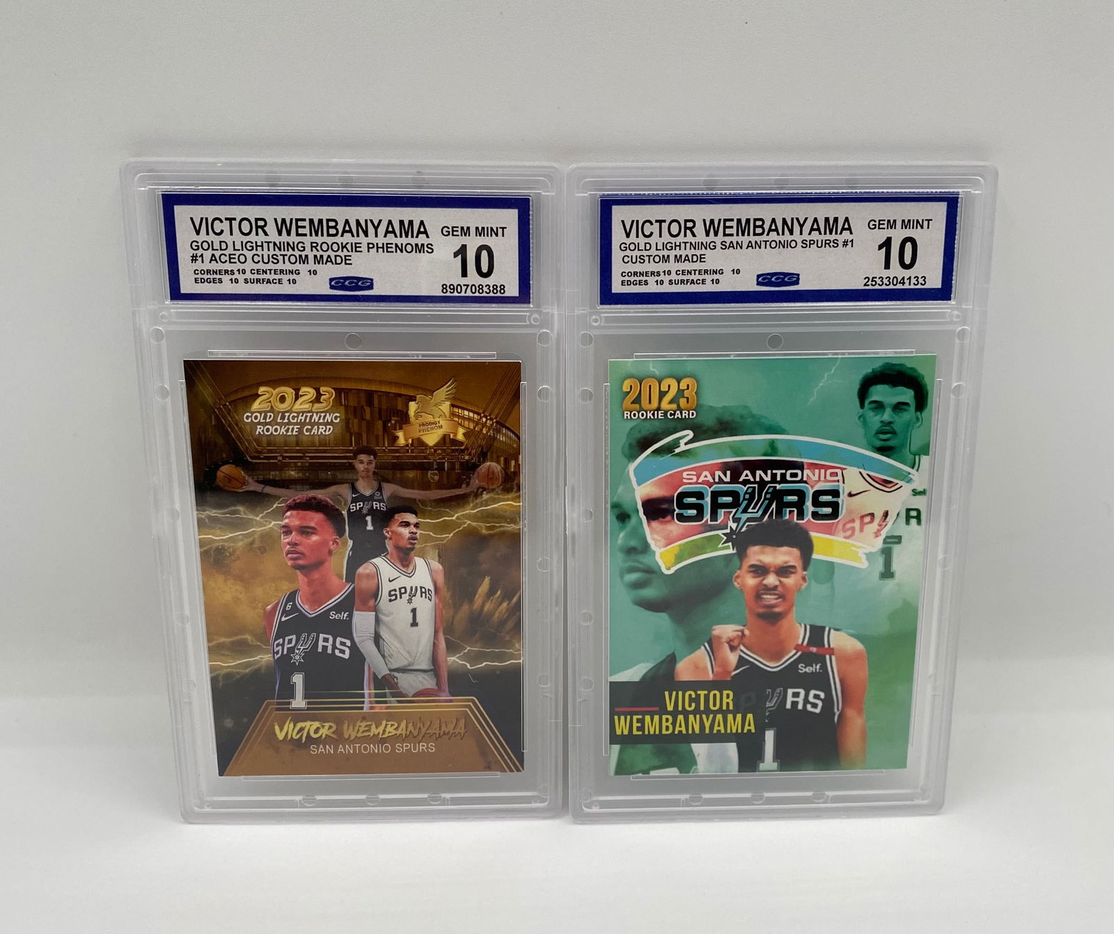 (2) Victor Wembanyama "Gold Lightning" Custom Rookie Cards - CCG 10 Gem-Mint: Card 1: 2023 Gold Lightning Rookie Phenoms #1 Custom. • Card 2: 2023 Gold Lightning San Antonio Spurs #1 Custom. • Details: Custom-made ACEO cards featuring the 2023 #1 overall pick.
