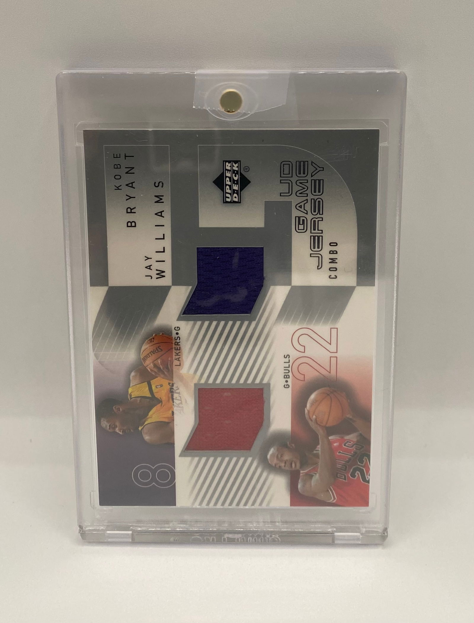 Upper Deck Game Jersey Combo - Kobe Bryant & Jay Williams - Dual Patch: Dual-player memorabilia card featuring Los Angeles Lakers legend Kobe Bryant and Chicago Bulls guard Jay Williams. Includes two multi-color jersey swatches embedded in the card. Housed in a magnetic