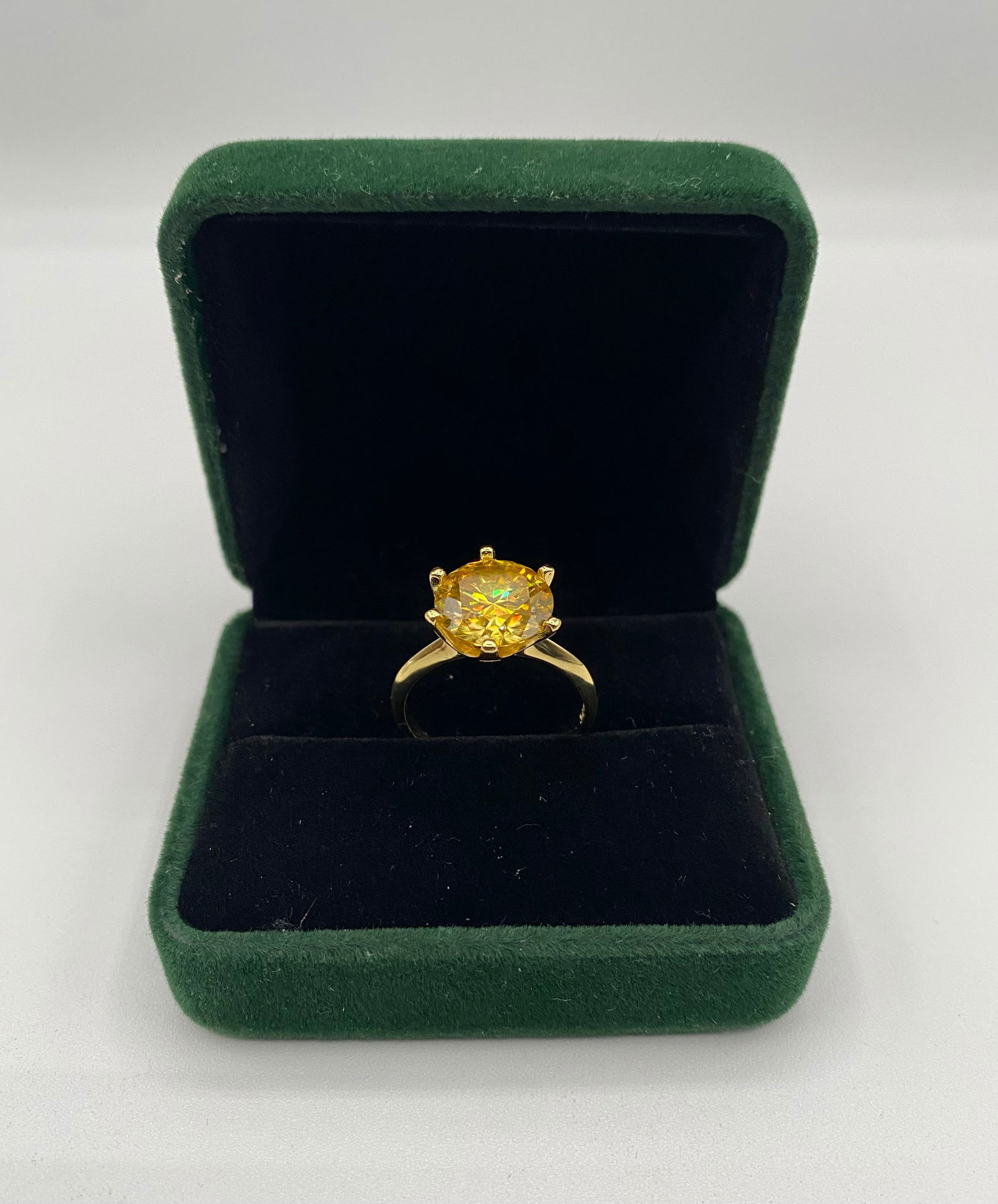 5.00 CT Fancy Yellow Moissanite Solitaire Ring - GRA Certified - 18K Gold Plated: Center Stone: 5.00 Carat Round Cut Moissanite in a stunning Fancy Yellow hue. Size: 7 1/2 • Metal: 18K Yellow Gold plated over .925 Sterling Silver. • Design: Classic 6-prong solitaire