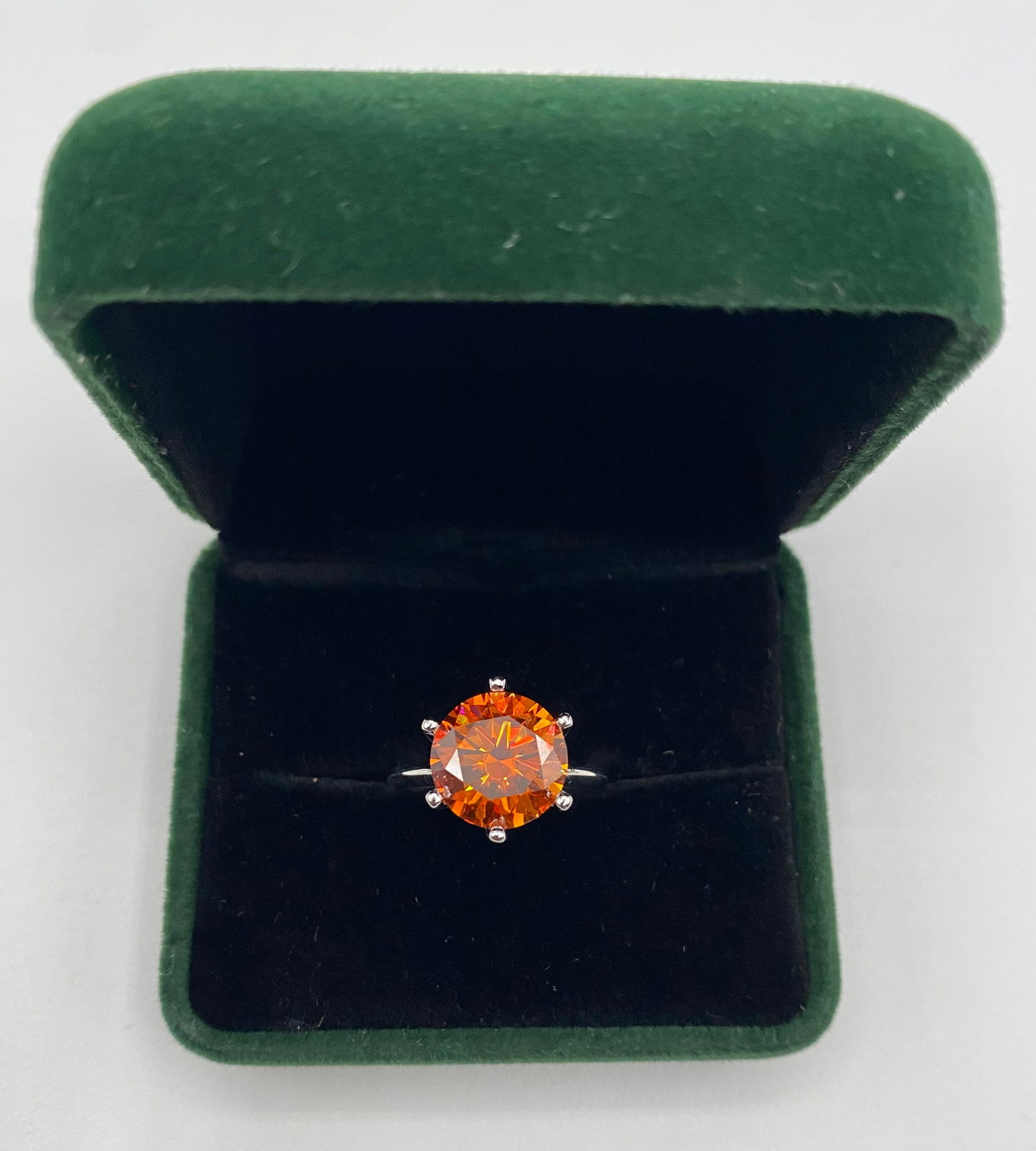 5.00 CT Cognac Orange Moissanite Ring - 18K Gold Plated Silver - Passes Tester - w/ GRA: Center Stone: Vivid Cognac Orange Round Cut Moissanite. • Carat Weight: 5.00 Carats. • Design: Classic 6-prong solitaire setting designed to showcase the unique color and fire of the