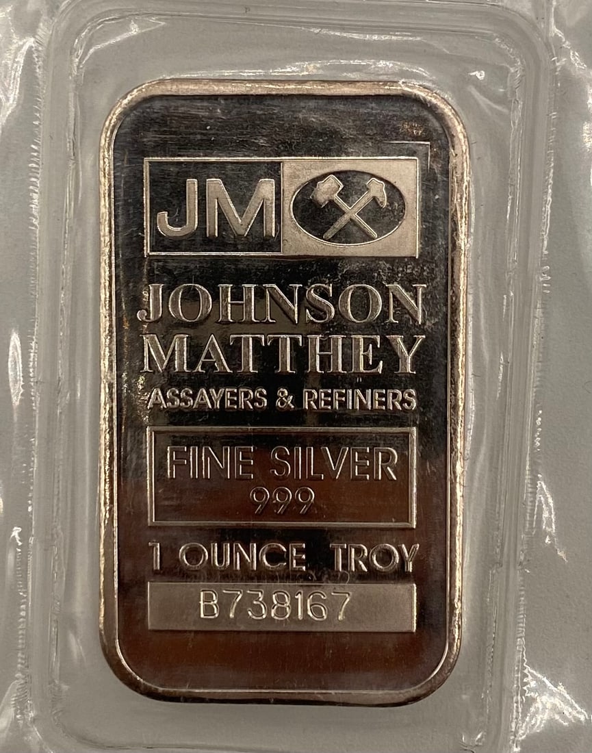 Johnson Matthey (JM) 1 Troy Ounce .999 Fine Silver Bar - Sealed: Manufacturer: Johnson Matthey • Weight: 1 Troy Ounce • Purity: .999 Fine Silver • Details: Features the iconic JM hammer logo and unique serial number (B738167). This bar comes in it
