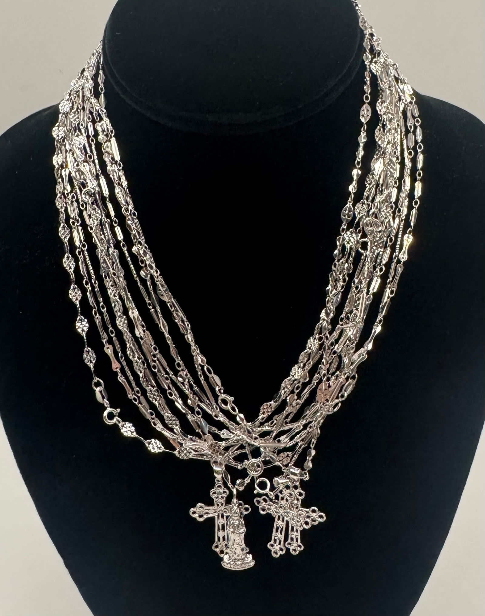 Religious Jewelry Lot Silver Multi-Strand Necklace Collection - Crucifix & Miraculous Medal Pendants: A beautiful assortment of silver- devotional jewelry featuring various chain styles and religious iconography. This lot offers a highly textured, layered aesthetic, perfect for everyday wear or as a t