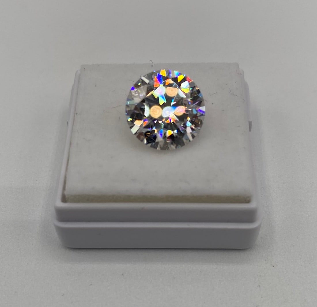 5.00 Carat Round Brilliant Cut Moissanite – GRA Certified – Passes Diamond Test: Gem Type: Real Moissanite • Shape: Round Brilliant Cut • Carat Weight: 5.00 Carats • Key Features: This lot features a classic Round Brilliant cut, known for maximum light return