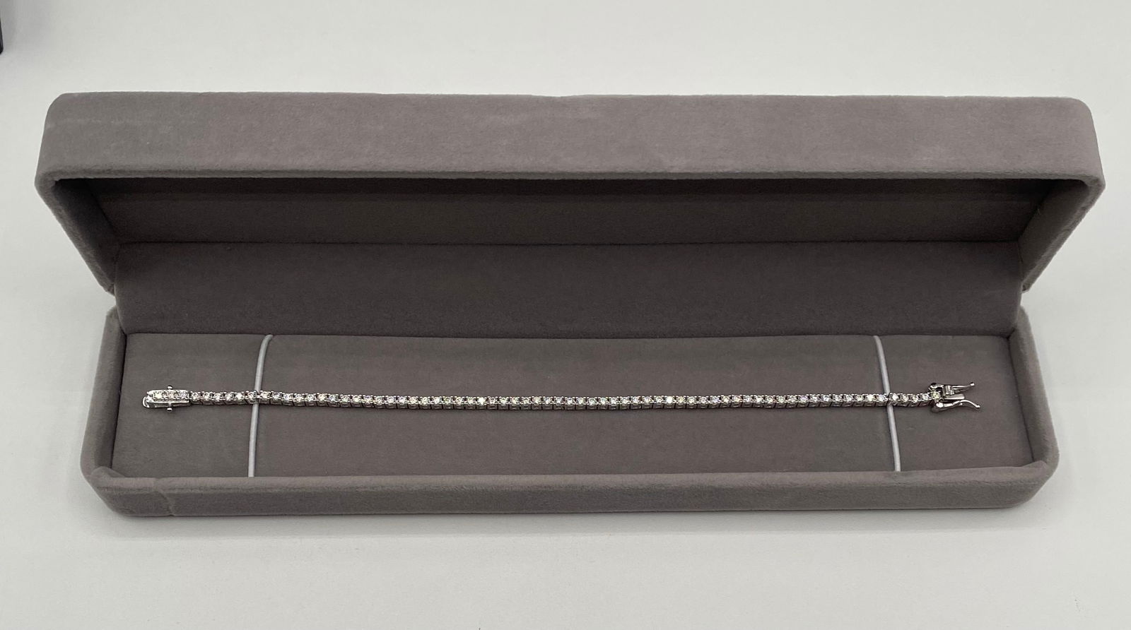 Classic Moissanite Tennis Bracelet - 18K Gold Plated 925 Silver - GRA Certified - Passes Tester: Style: Timeless Single-Row Round Cut Tennis Bracelet. • Stones: Premium Moissanite stones with exceptional fire and brilliance. • Authentication: Individually tested; passes as Diamond