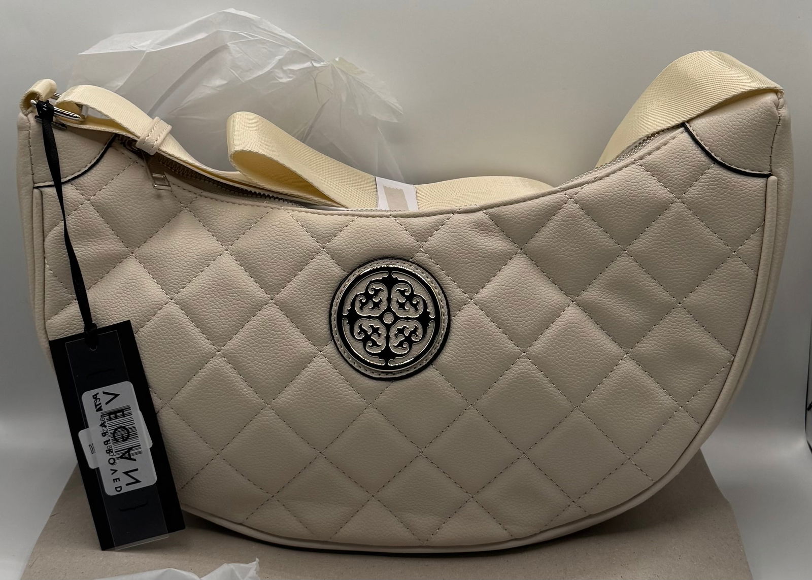 DELUXITY Los Angeles Quilted Vegan Leather Crescent Crossbody Bag - Cream: Brand: DELUXITY Los Angeles Style: Quilted Crescent / Half-Moon Crossbody Shoulder Bag Color: Cream / Off-White Dimensions: 14" W x 8" H Key Features: • Premium Vegan Materials: