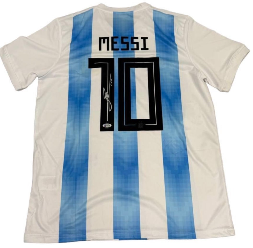 Lionel Messi Autographed Signed Argentina Jersey – Beckett Authenticated – World Cup Era: Player: Lionel Messi • Team: Argentina National Team • Details: Classic "Albiceleste" sky blue and white striped jersey with Messi’s iconic #10. Signature is crisp and prominently