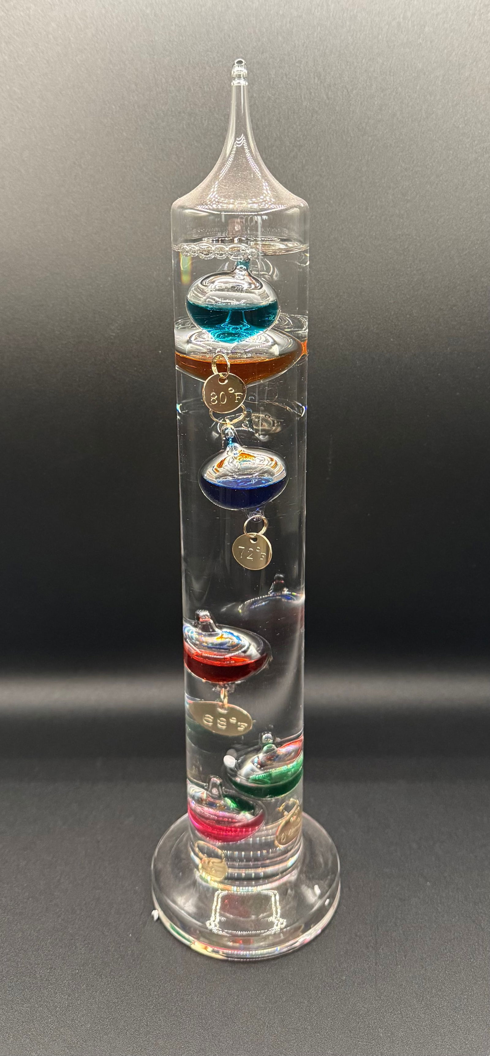Gift Essentials Galileo Thermometer - Hand Blown Glass - 60° to 96°F: Add a touch of 17th-century scientific elegance to your home or office with this Galileo thermometer by Gift Essentials. This decorative instrument functions on the principle of buoyancy, featuring