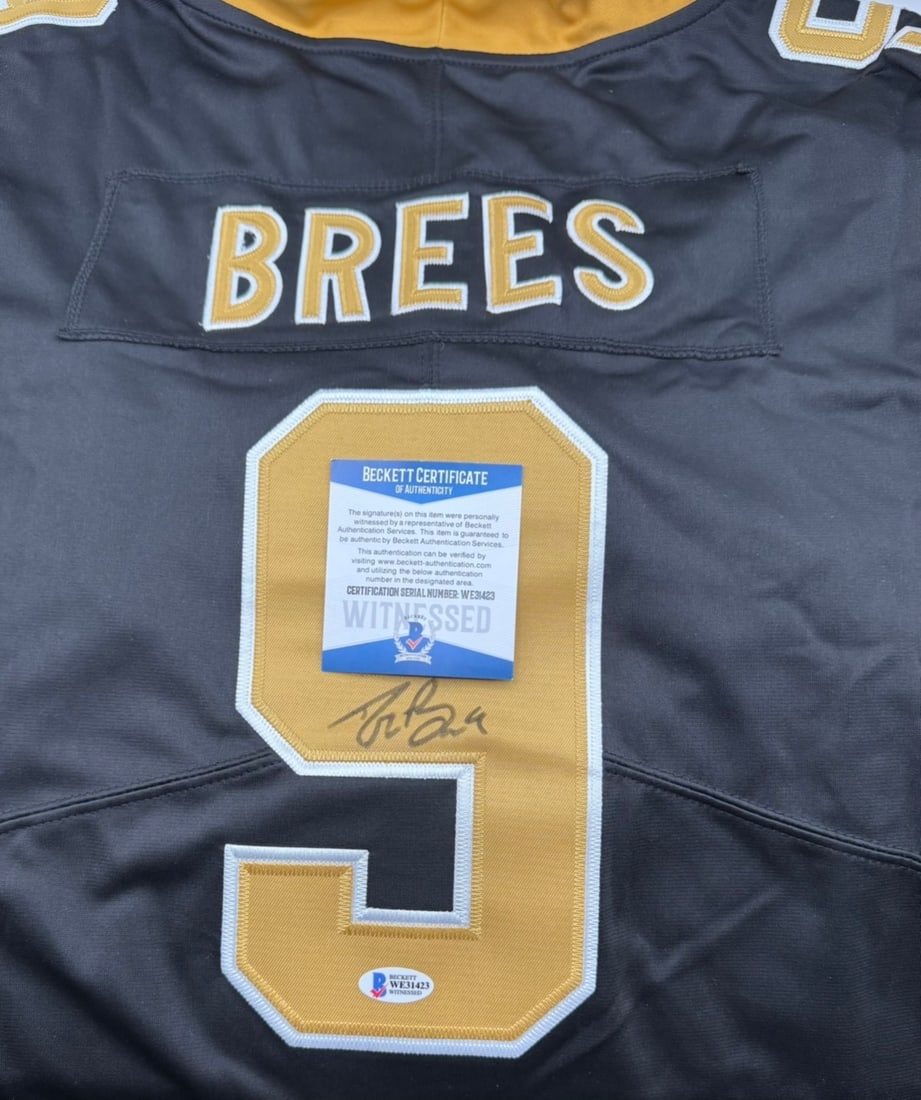 Drew Brees Signed New Orleans Saints Jersey – Beckett Witnessed Authentic: Celebrate one of the greatest quarterbacks in NFL history with this hand-signed New Orleans Saints-style jersey from Drew Brees. Signed in silver ink on the gold #9, this piece is a must-have for
