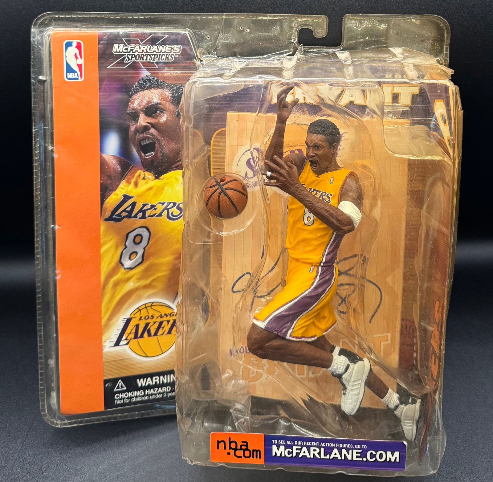 Kobe Bryant Figure Signed: McFarlane’s SportsPicks NBA Series 1 Kobe Bryant Figure - Los Angeles Lakers. The wood part of it is signed .• Packaging: The plastic clamshell shows significant shelf wear, including