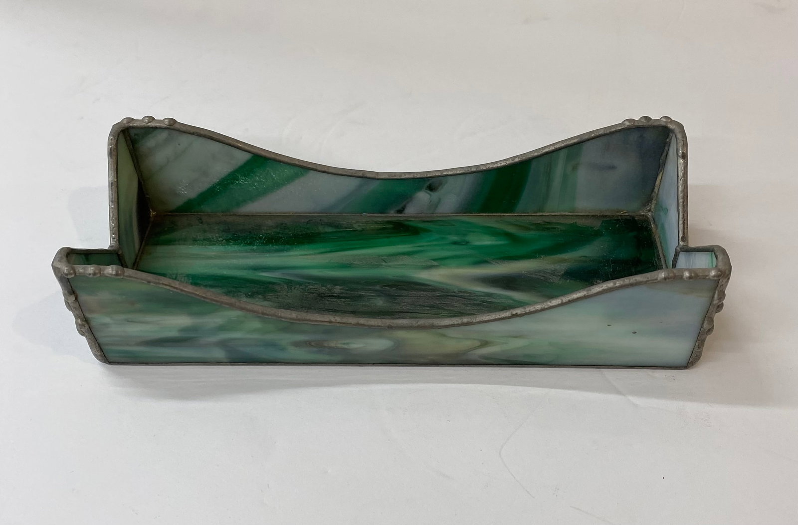 Handcrafted Green Slag Glass & Solder Letter/Napkin Holder: A unique artisan piece made of swirled green and white slag glass panels. Assembled with decorative lead solder beading along the scalloped edges. Ideal for use as a napkin holder or a desk organizer