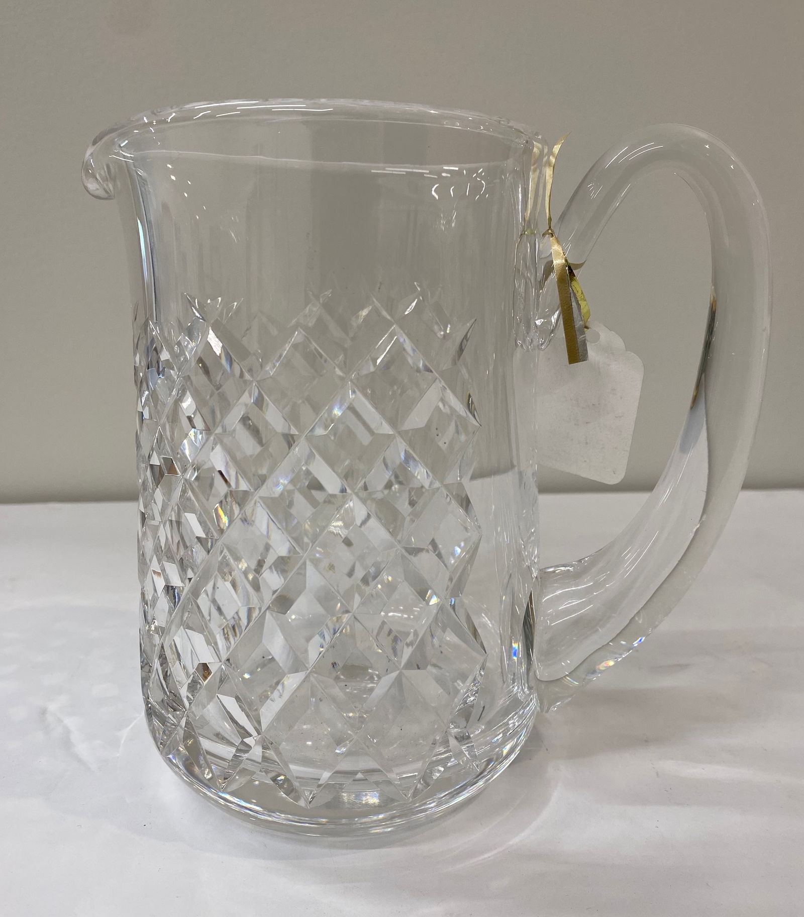 Waterford Crystal 1.5qt Water Pitcher – Lismore Pattern: A substantial lead crystal pitcher featuring the iconic Lismore diamond and wedge cuts. Includes a graceful applied handle and polished pouring lip. Acid-etched Waterford signature present.
