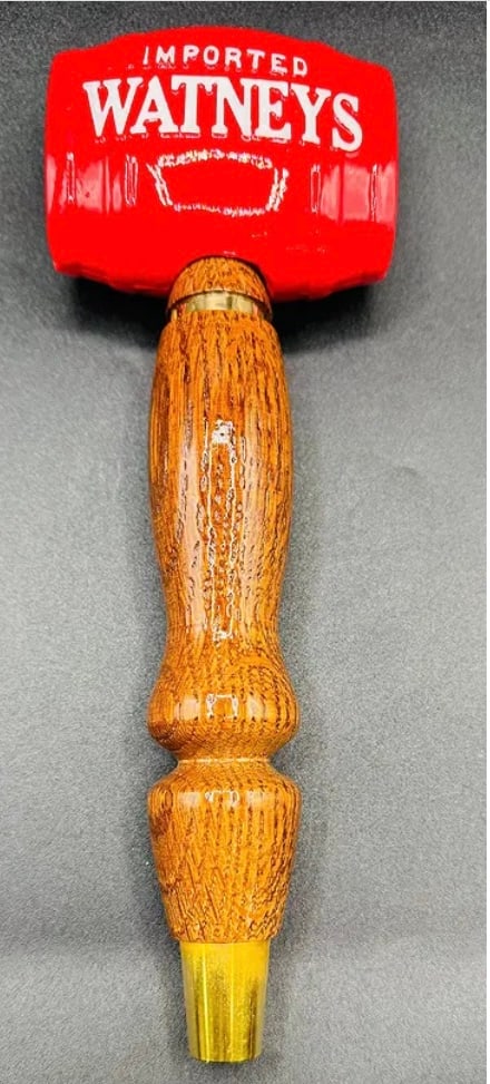 Vintage Watneys Imported Beer "Mallet" Tap Handle – Rare Wood & Resin: A unique and rare "mallet" or "gavel" style tap handle for Watneys. Features a heavy red resin head with white "Watneys" lettering and a turned wood-grain handle. • Brand: Watneys (United Kingdo