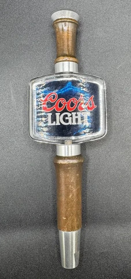 Vintage Coors Light Beer Tap Handle - Wood & Acrylic - Barware Decor: Brand: Coors Brewing Co. • Style: Coors Light • Design: Features a rectangular acrylic logo block set between two turned wood spindles with aluminum accents. • Material: Wood, acryli