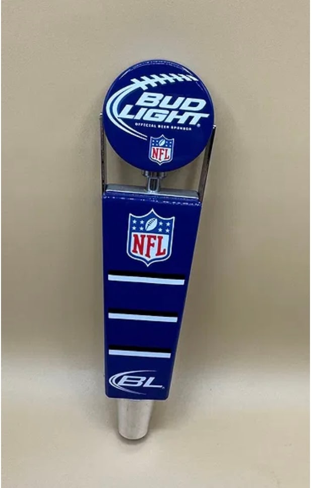 Bud Light NFL Official Sponsor Shield & Football Beer Tap Handle: A classic collectible for sports fans, this Bud Light tap handle features a circular football-themed top and the official NFL shield logo on a sleek blue tapered body. • Dimensions: Approx. 10"