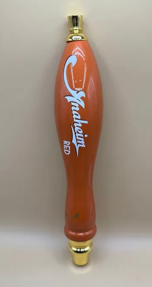 Vintage Anaheim Red Ale Ceramic Beer Tap Handle - Orange: A classic, surfboard-style ceramic tap handle for Anaheim Red. Features a vibrant orange finish with the "Anaheim" script in white and "RED" in block lettering. Topped with a polished gold-tone finial