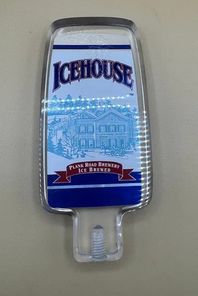 Icehouse Beer Tap Handle - Plank Road Brewery Ice Brewed: A rectangular clear acrylic tap handle featuring the iconic Icehouse branding. The insert displays the Plank Road Brewery winter scene illustration and "Ice Brewed" ribbon logo. • Condition: