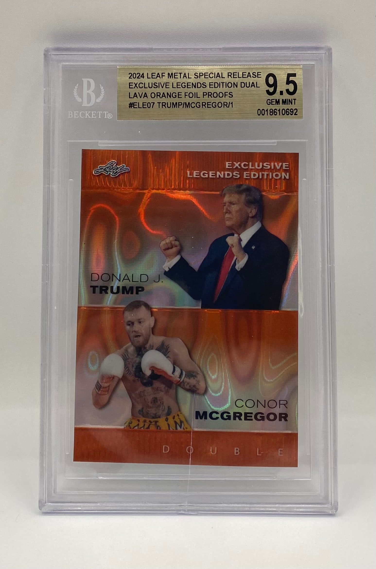 Donald Trump & Conor McGregor Lava Orange 1/1: Card: 2024 Leaf Metal Special Release Exclusive Legends Edition Dual #ELE07. • Subjects: Donald J. Trump and Conor McGregor. • Grade: Beckett (BGS) 9.5 Gem Mint. • Details: Extremely